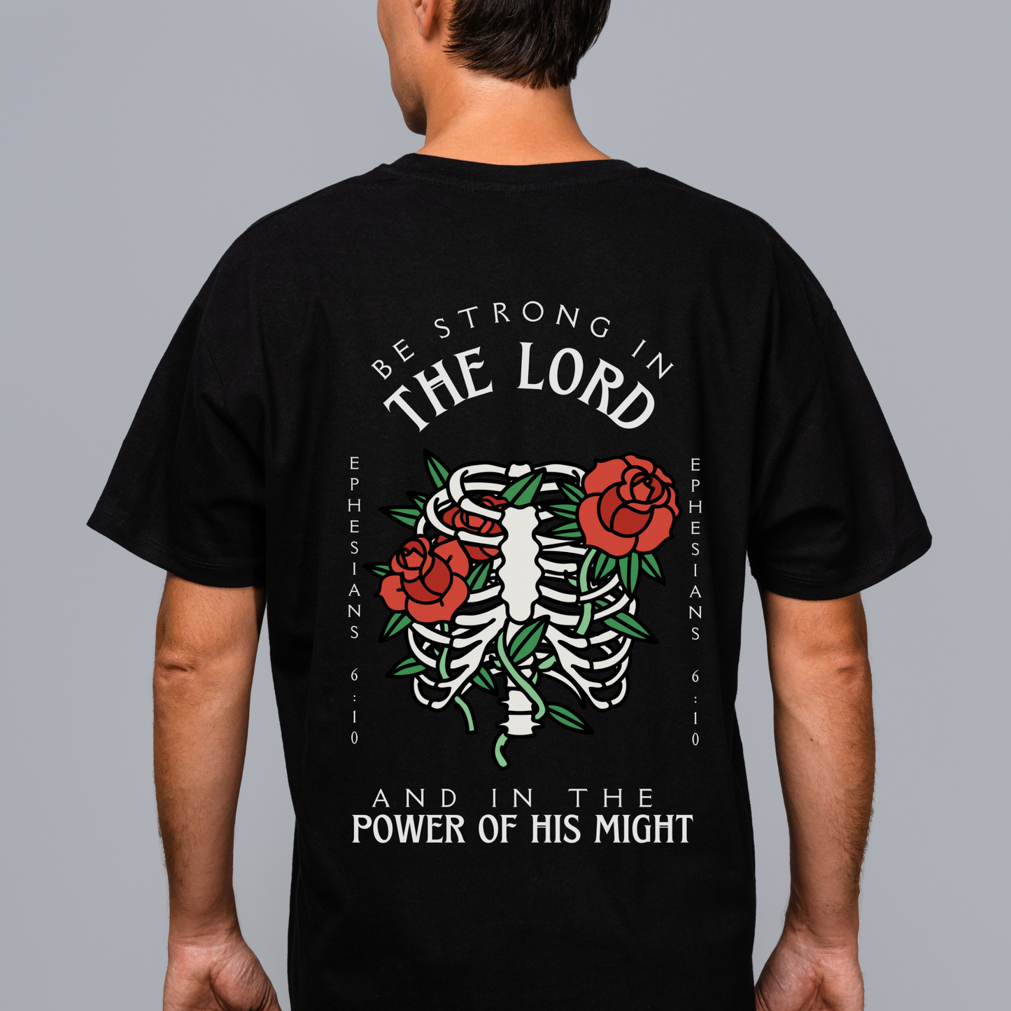 backside of a mens christian streetwear shirt in black with short sleeves that says be strong in the lord