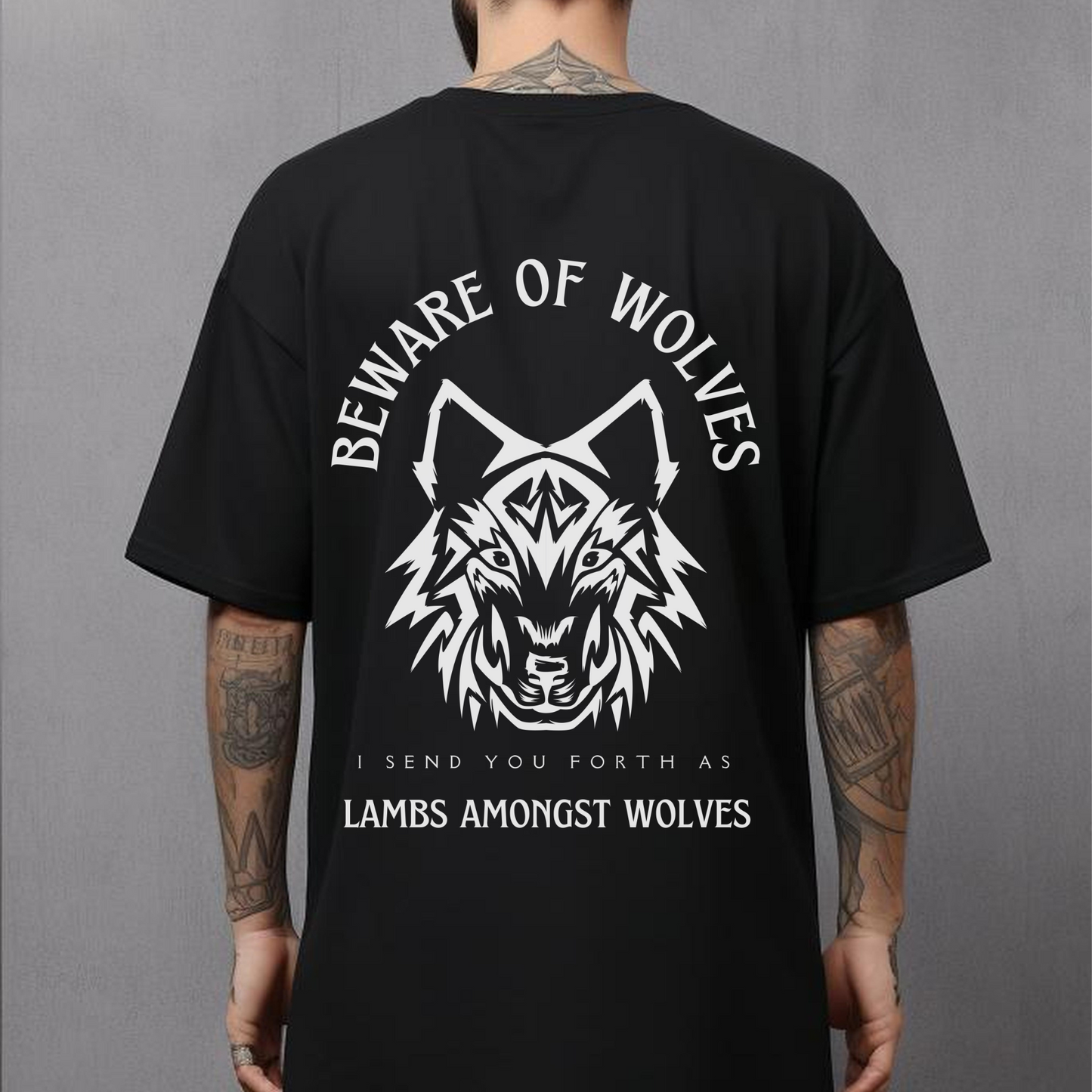 man wearing a mens christian religious shirt with a back design of a wolf that says beware of wolves