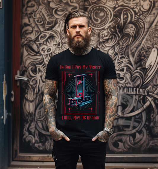 tattooed man wearing a black crewneck short sleeve christian graphic tee with the image of a guillotine that says in god i put my trust I will not be afraid