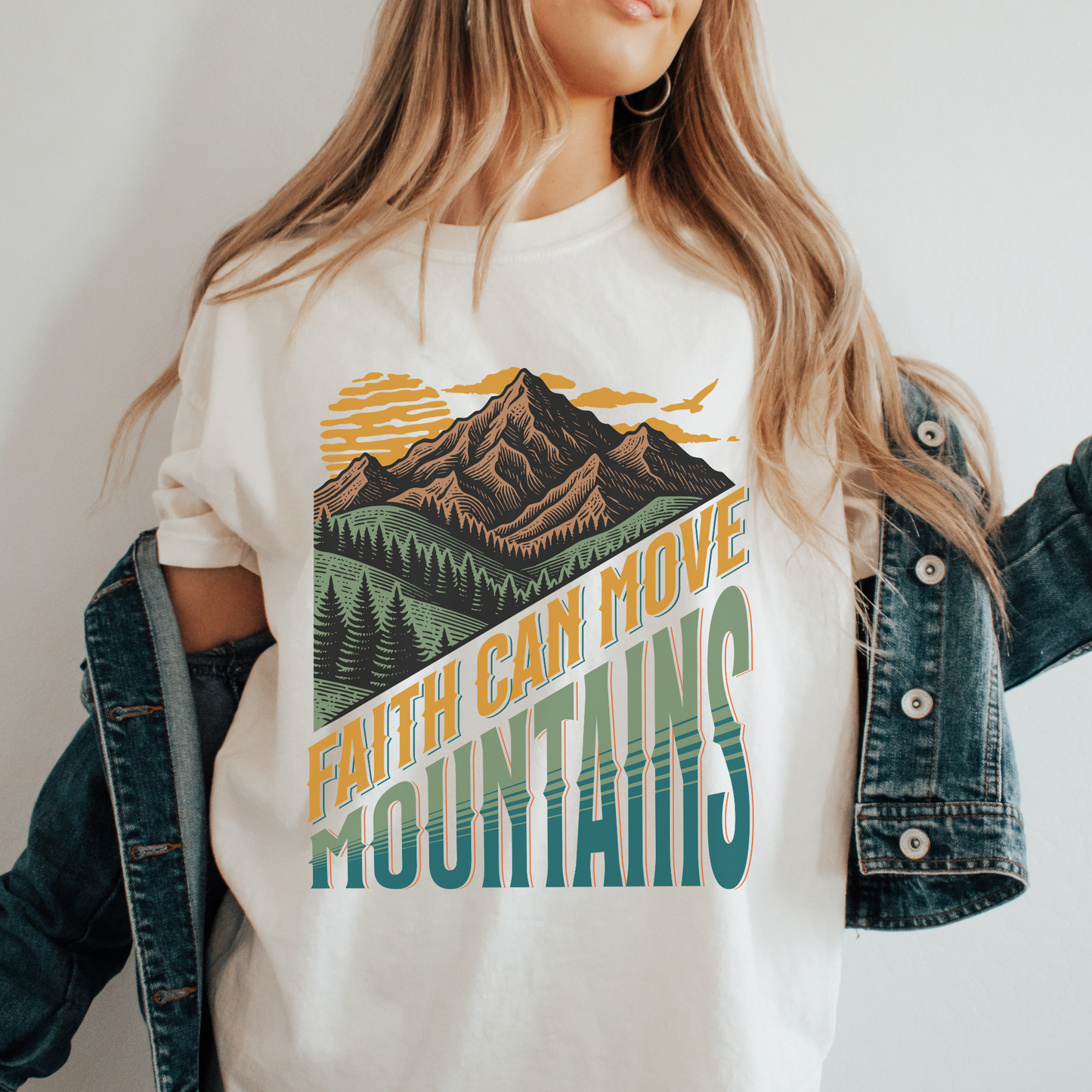 women wearing a faith can move mountains tshirt with mountain landscape