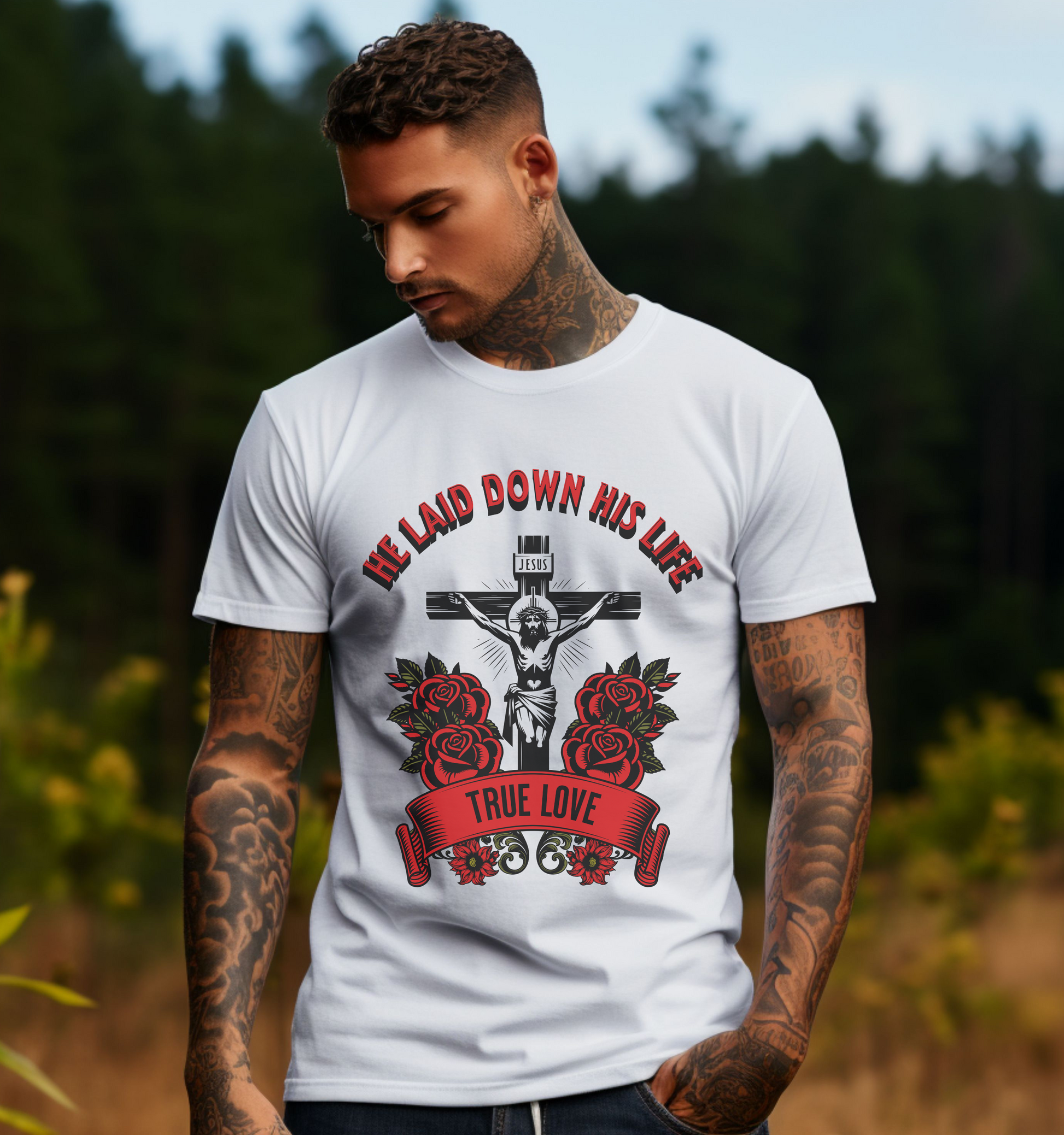 man wearing a white crewneck short sleeve jesus t-shirt that says he laid down his life with the image of jesus on the cross surrounded by roses